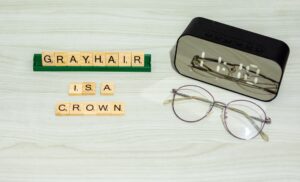 clock, scrabble letters, that say grayhair is a crown